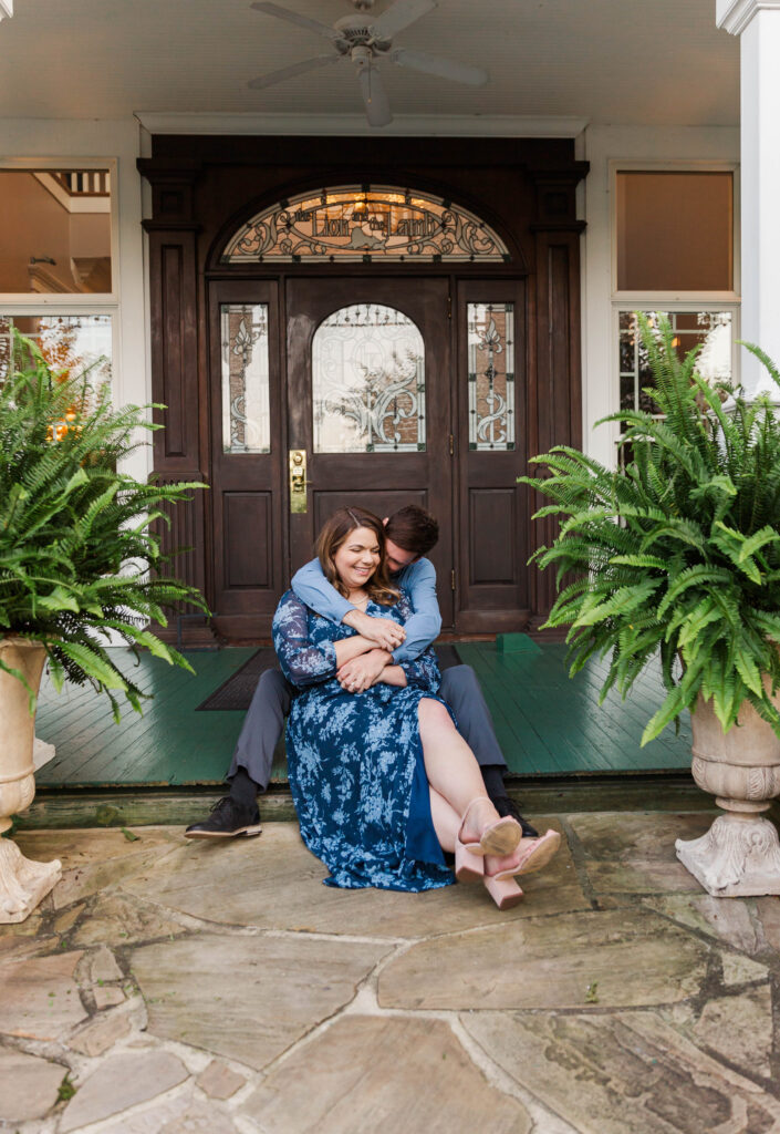 couple snuggling together on porch. knoxville engagement photographer