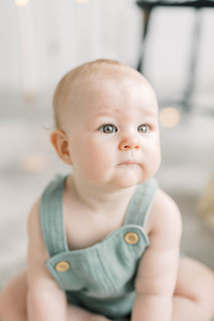close up of baby boy sitting on the floor. knoxville baby photographer
