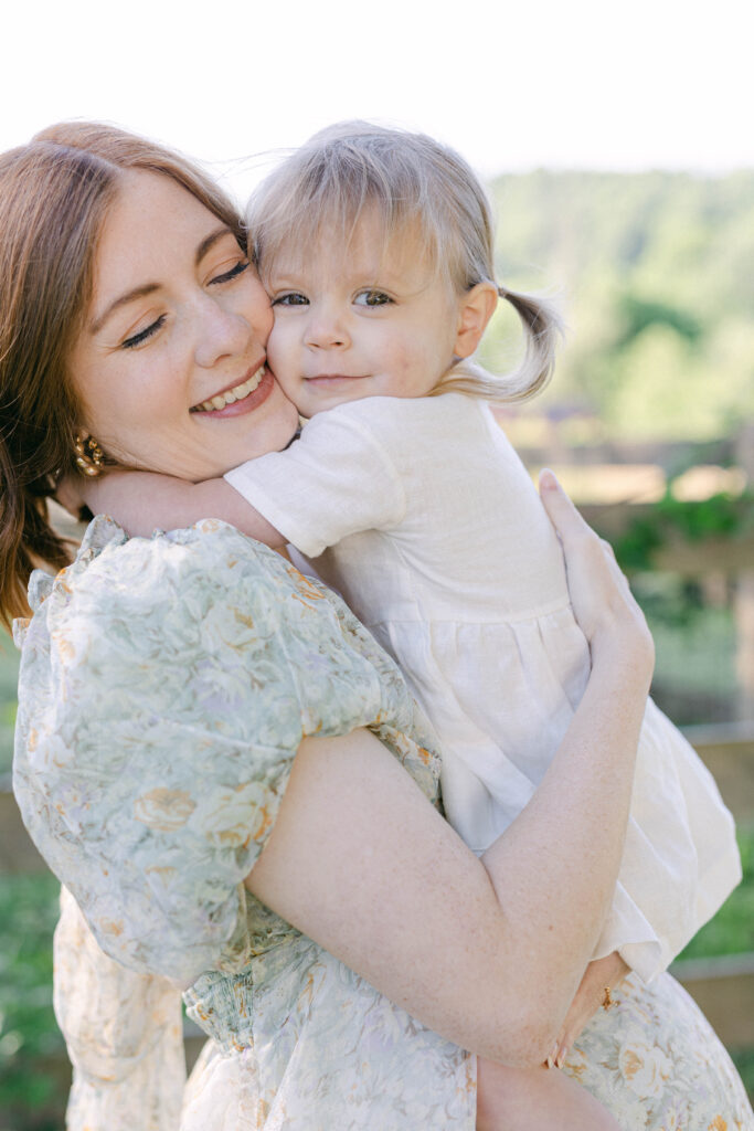 mom and daughter hugging close. knoxville maternity photographer. holmstead studio